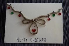 a christmas card with an ornament hanging from it