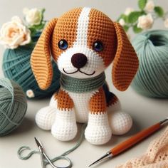 a crocheted dog sitting next to yarn and scissors