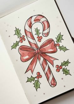 a christmas card with candy canes and holly