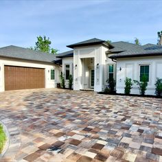 a large brick driveway in front of a house