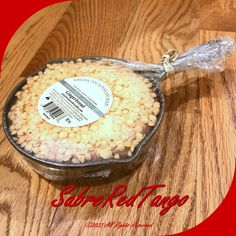 a container filled with white beans on top of a wooden table next to a red circle