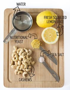 a cutting board with lemons, cashews and other ingredients