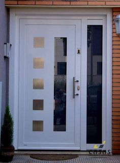 a white double door with glass panels and sidelights on the outside of a house