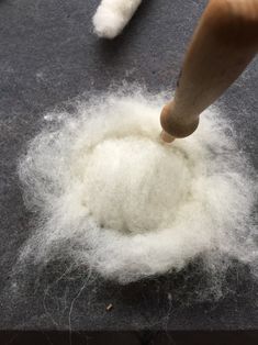 someone is throwing wool into the floor