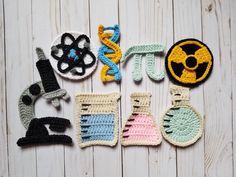 several crocheted objects are arranged on a wooden surface