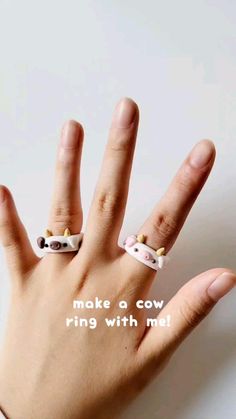 a person's hand with two rings on it and the words make a cow ring with me