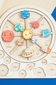 a wooden clock with different planets on it