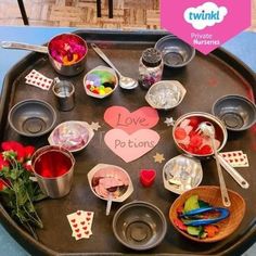 a tray filled with lots of food and utensils on top of a table