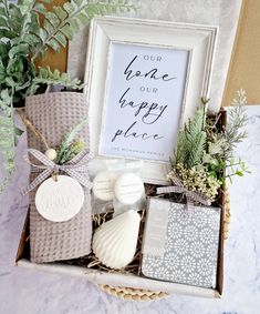 a gift box filled with personalized items and a framed sign that says, youre our happy place