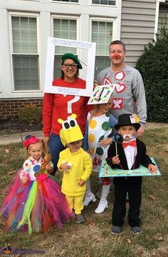 a group of people in costumes posing for a photo with two children and one adult