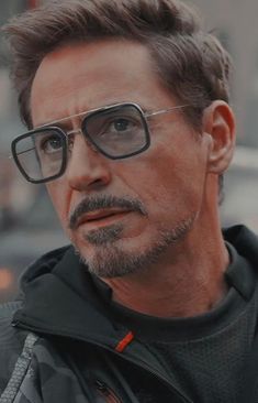 the man is wearing glasses and looking at something