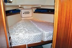 the inside of a small boat with two beds