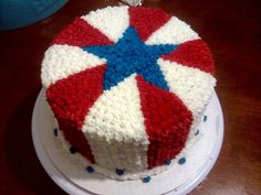 a red, white and blue cake sitting on top of a table