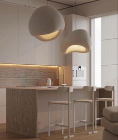 an image of a modern kitchen setting with lights hanging from the ceiling and stools on the floor