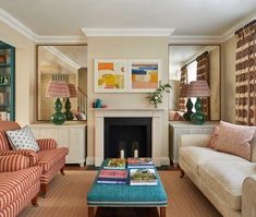 a living room with two couches and a coffee table in front of a fireplace