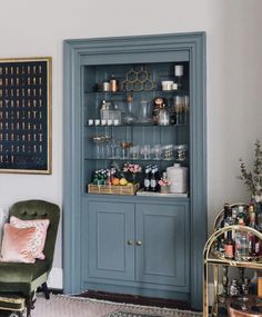 a blue china cabinet in the corner of a room