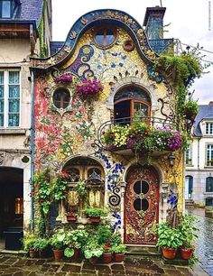 a colorful house with lots of windows and flowers