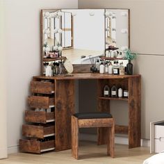 a dressing table with drawers and a mirror on the wall next to it in a room