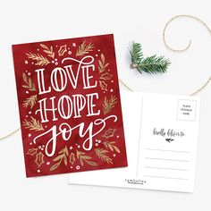 a postcard with the words love, hope and joy on it next to an envelope