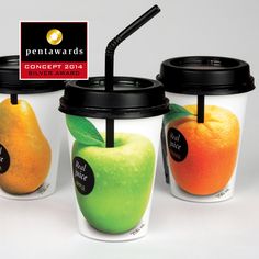 three coffee cups with fruit in them and one has a black lid, the other has a green apple