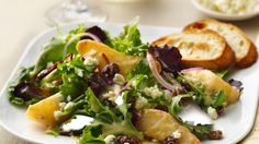 a white plate topped with salad and bread