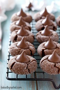 there are many cookies with chocolate frosting on the cooling rack