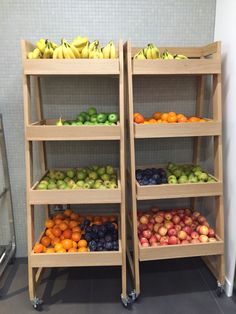 two wooden shelves filled with different types of fruit