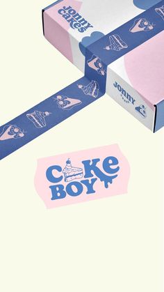 a cake box with blue and pink designs on the side, next to it's packaging