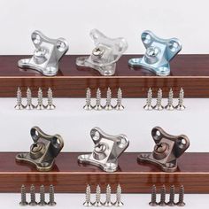 there are many different types of brackets on the shelf with screws and nails in them