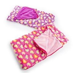 three pieces of pink and purple clothing with hearts on them, one is folded over the other