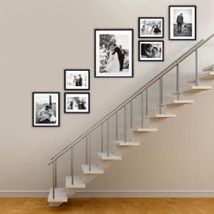 a staircase with pictures on the wall next to it