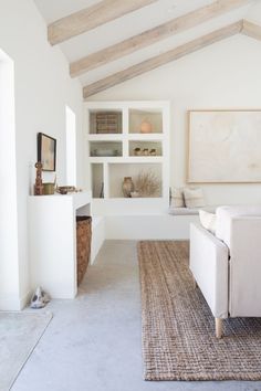 a living room filled with furniture and white walls