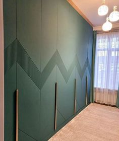 an empty room with green walls and curtains