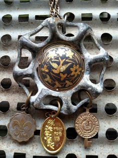 four different types of key chains hanging from a metal grate with holes in it