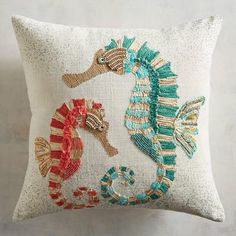 a decorative pillow with seahorses on it