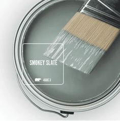 a can of smokey slate paint with a brush in it's tint