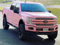 a pink truck parked in a parking lot