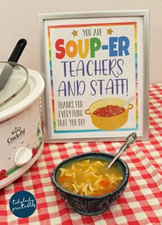 a bowl of soup next to a sign that says you are super teachers and staff