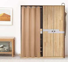 a room with a wooden cabinet and curtains