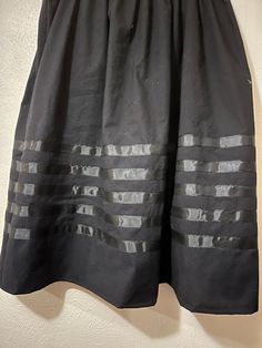 Ribbon skirt - black and black Ribbon Skirt - Skirt has an elastic waist that gives it the elusion of an A-line skirt.  Most skirts are 100% cotton or primarily cotton. Authentic Native American design for Pow Wow and Native American dances.  This skirt is meant to be a mid-calf-length skirt and is typically 31 - 32 inches. If you need it shortened, please let me know. This skirt can be made into a long skirt. If you do not find it on the LONG skirt post please message me for instructions. PLEASE CHOOSE YOUR SIZE BELOW!!  RUSH SHIPPING: If you need to rush your shipping, (anything out of the normal time frame for making your order) please note that I use USPS Priority Mail. You can change the shipping if you need to but please note, you will be charged for it and  I will also ask you to pa Native American Dance, Ribbon Skirt, Black And Black, Ribbon Skirts, Calf Length Skirts, Native American Design, Ankle Length Skirt, Beaded Jewlery, Pow Wow