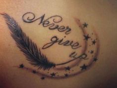 the back of a woman's stomach with an arrow and stars tattoo on it