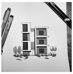 a drawing of a building with trees and bushes next to it, on top of a piece of paper