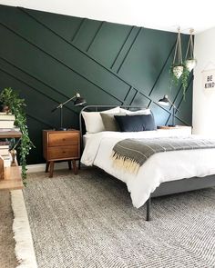 a bed room with a neatly made bed next to a window and a rug on the floor