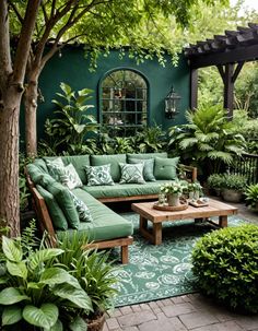 a living room with green couches and potted plants