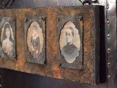 three framed pictures are hanging on the wall next to an iron frame with metal rivets