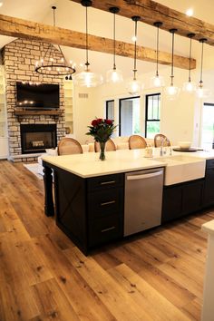 a large kitchen with an island, stove and dining room table in the center area