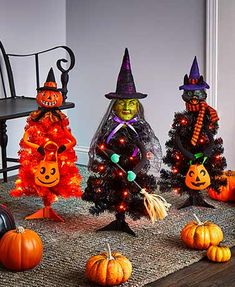 three halloween trees decorated with pumpkins and witches