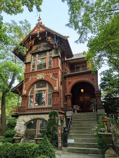 an old house with stairs leading up to it