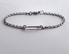 Oxidized sterling silver minimalist unisex chain bracelet with large link center and swivel clasp. Perfect for everyday wear! Choose your length: 5 ½, 6, 6 ½, 7, 7 ½, 8, 8 ½, 9, 9 ½ inches. Unisex - minimalist masculine styling great for men or women. Center sterling silver link is 7 x 17mm (5/8 inch long) and the main bracelet chain is a 2.8mm sterling silver round cable chain. High quality swivel lobster clasp makes sure the bracelet is never twisted. Bracelet is medium oxidized and polished/b Everyday Chain Bracelet With Rectangular Links, Everyday Silver Chain Bracelet With Rectangular Links, Sterling Silver Chain Bracelet With Solid Link For Everyday, Everyday Sterling Silver Link Paperclip Bracelet, Everyday Sterling Silver Paperclip Link Bracelet, Everyday Sterling Silver Oval Link Cable Chain Bracelet, Sterling Silver Link Bracelet For Everyday, Everyday Sterling Silver Paperclip Chain Bracelet, Sterling Silver Link Bracelets For Everyday Wear