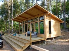 a small wooden cabin sitting in the middle of a forest